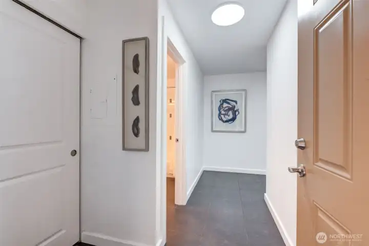 Spacious entry with coat closet. Hall bath is the first doorway on left. Ceramic tile floors and freshly painted interior.