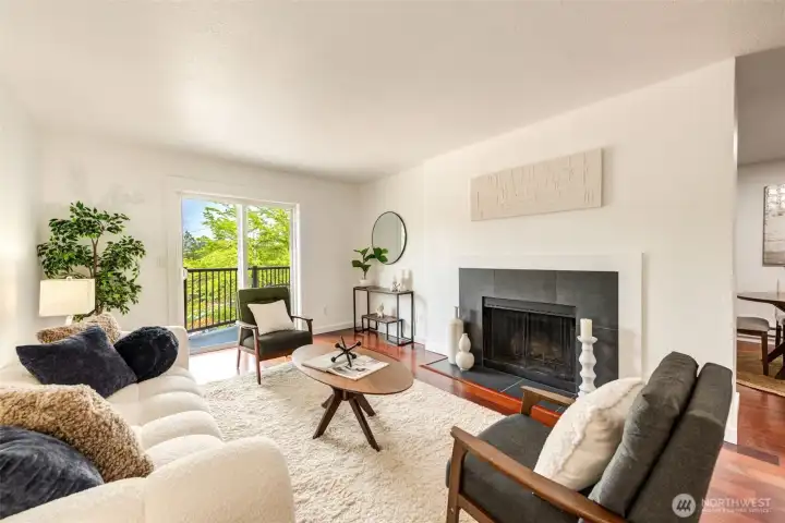 Inviting living room with wood burning fireplace and access to balcony.