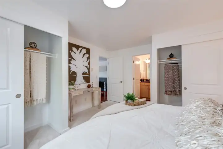 Another view of the primary suite showing double closets and door to full bath.