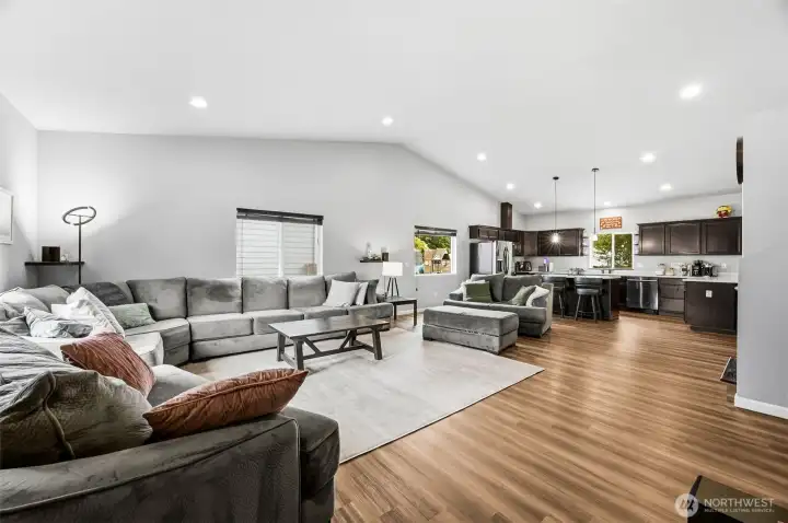 Vaulted ceilings and abundant natural light create a bright, open-concept living space designed for comfortable everyday living.