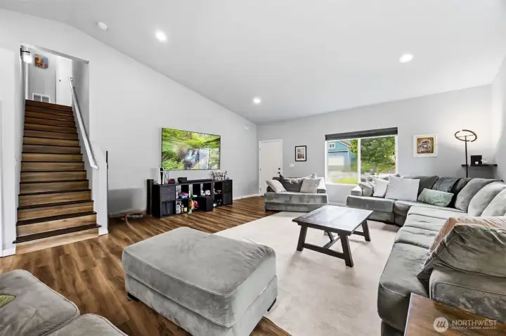 Open-concept design offers flexible living spaces with soaring ceilings and durable flooring throughout the main level.