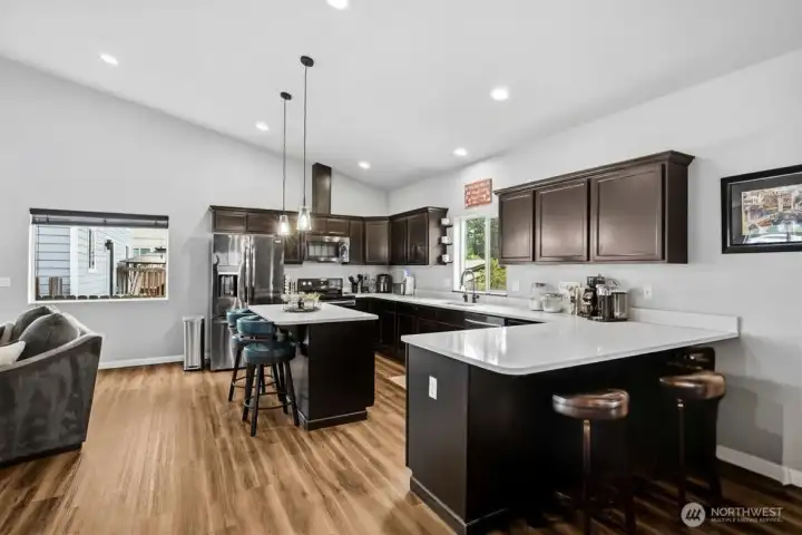 Thoughtfully designed kitchen with instant hot water, expansive counters, breakfast seating, and abundant storage.