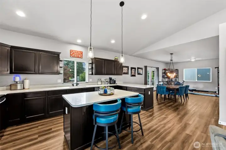 Open sightlines connect the kitchen, dining, and living areas—perfect for entertaining or keeping everyone together.