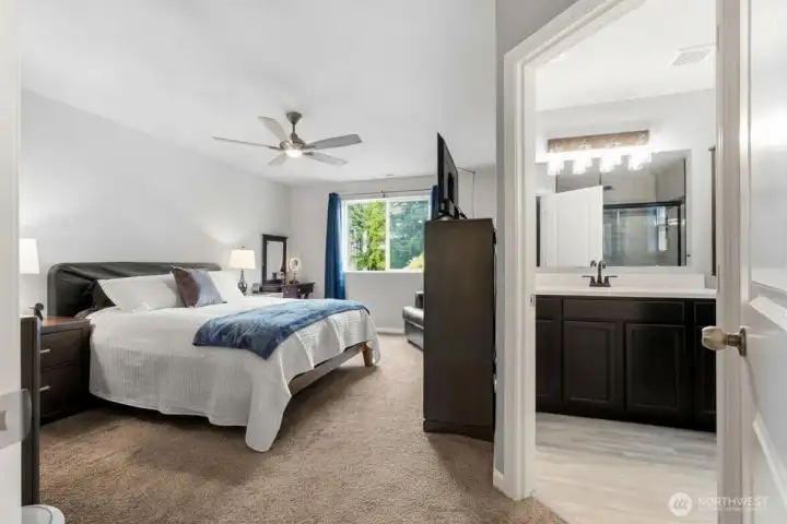 Spacious primary retreat featuring a walk-in closet and beautifully remodeled spa-inspired ensuite bath.
