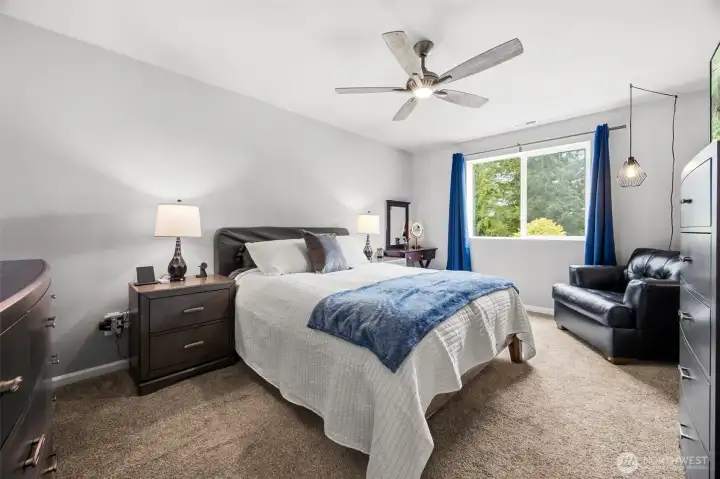 Relax and unwind in the generously sized primary bedroom filled with natural light and offering plenty of space for a king-size bed and sitting area.