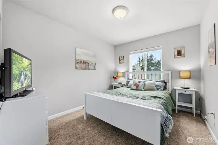 Comfortable secondary bedroom filled with natural light and generous closet space.