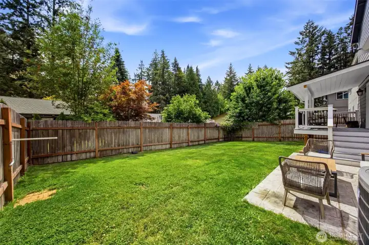 Expansive, fully fenced backyard offers plenty of space for pets, play, gardening, and outdoor entertaining.