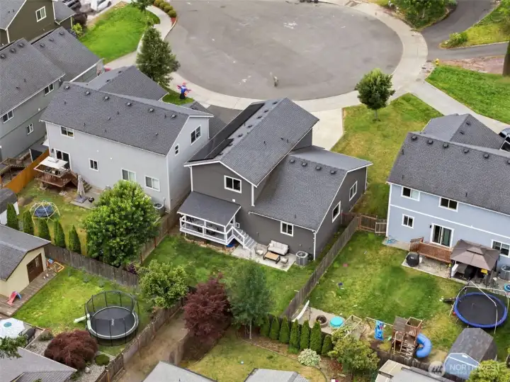 Aerial view highlighting the generous lot, fully fenced backyard, long driveway, and ideal cul-de-sac location.