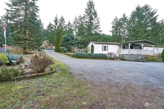 Driveway, side yard, home and lots of parking. Meditation garden on left side.