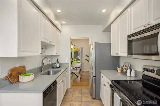 The updated kitchen has stainless appliances and quartz countertops