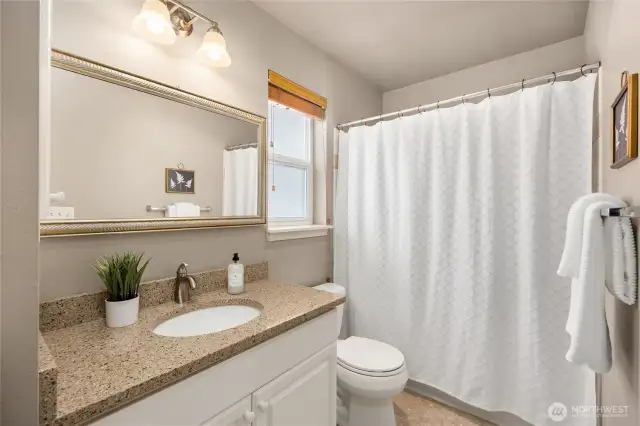 The bedroom includes a full ensuite bathroom with updated quartz countertops