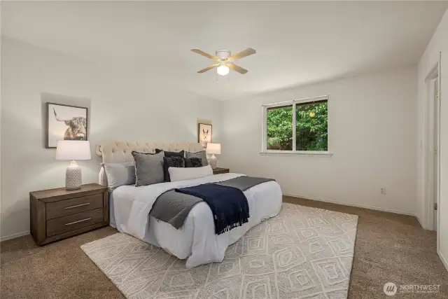 Good sized primary bedroom with pocket door directly to upstairs bathroom and a walk in closet. Bedroom has a very private view into backyard forest.