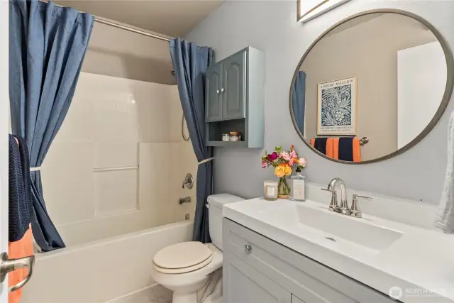 Downstairs bathroom with updated vanity and large tub/shower.