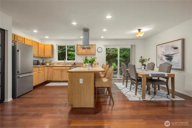 Counter seating in this open kitchen and a good sized dining room that fits a large table. From the dining area is a slider that goes out to the ultra private backyard and huge deck with hot tub!