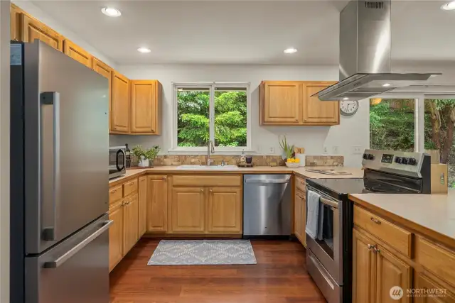 All stainless appliances and range hood. Great view from the sink onto the deck and fully forested backyard.