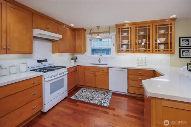 Bright and sunny kitchen with new quartz countertops, backsplash and range.