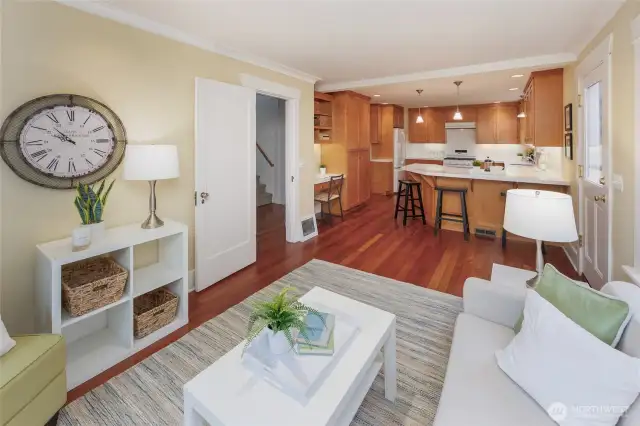 Family room adjacent to the kitchen with breakfast bar and built in desk has french doors to the fully fenced yard with multi-level deck.