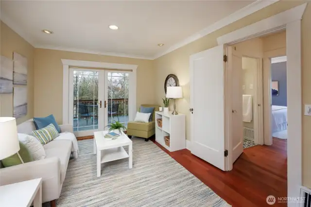 Family room off the kitchen with french doors to the multi-level deck and fully fenced backyard.