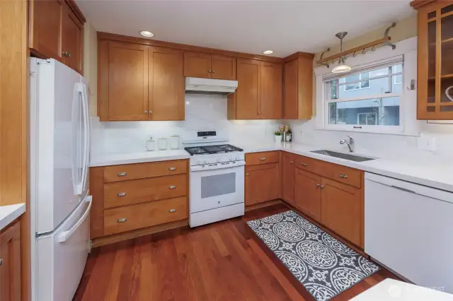 Bright and sunny kitchen with new quartz countertops, backsplash and range.