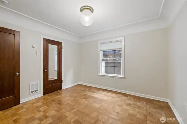 Door with mirror leads to kitchen, door on left to hallway
