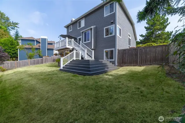 Expansive, fully fenced backyard provides a private and elegant outdoor setting with ample space for entertaining, gardening, or peaceful relaxation