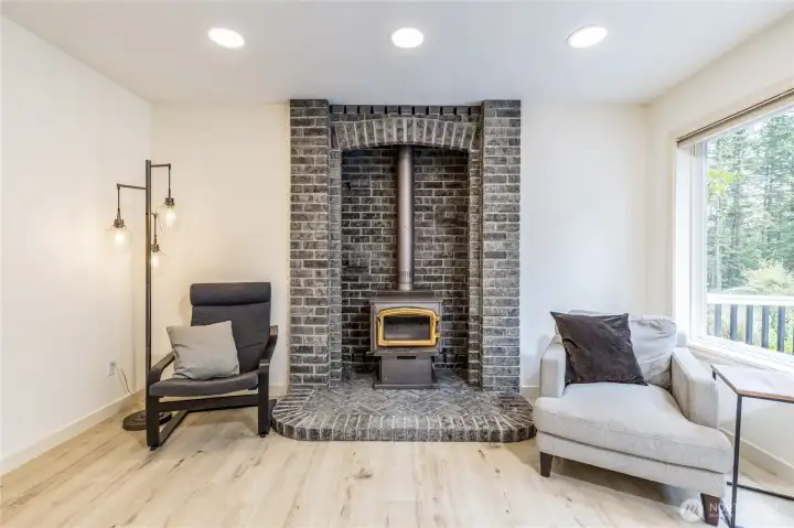 The wood-burning stove adds warmth and character, becoming the natural focal point of the family room