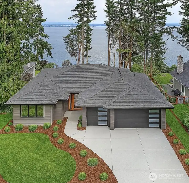 Stunning modern rambler perched above Port Susan with breathtaking water views. Sleek lines, oversized garage doors, and a striking entry create a bold first impression. Designed for both style and comfort, this home blends Northwest elegance with contemporary architecture, all set against a serene waterfront backdrop.