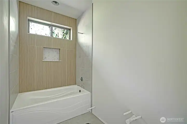Clean and functional design with tiled tub/shower combo.