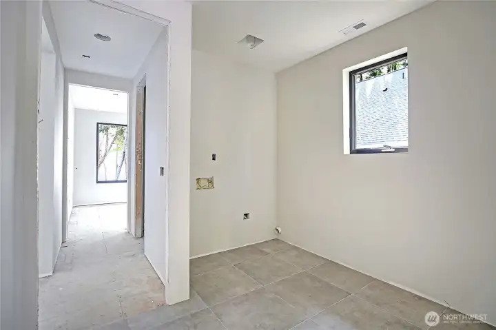Laundry room offers convenience with a dedicated sink, W/D, and ample space for storage and organization.