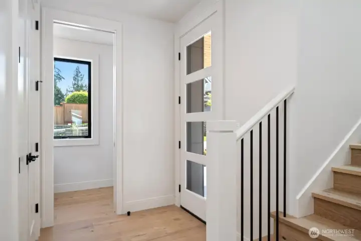 Well-lit entrance with glass paneled front door