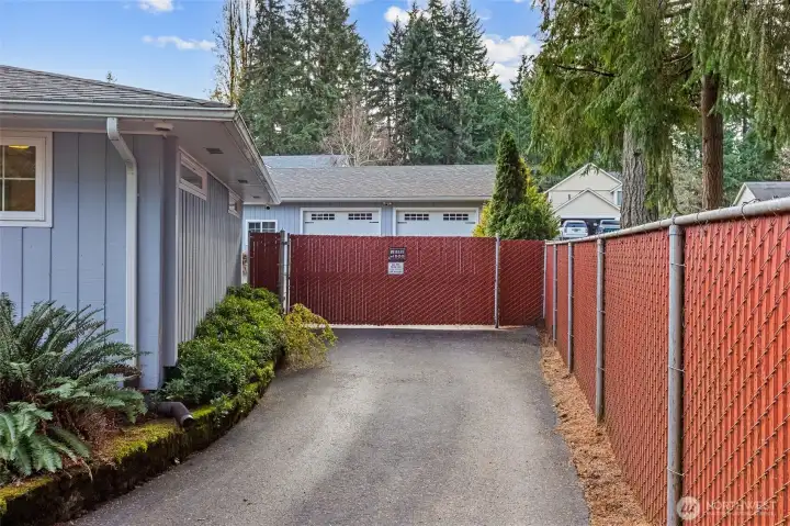 Backyard features an automated fencing gate, providing effortless, remote-controlled entry for vehicles, pets, and added privacy