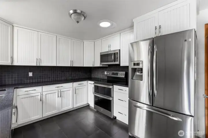 Enjoy a chef-inspired kitchen featuring a stainless steel fridge and double over, designed for efficient cooking, baking and family meals