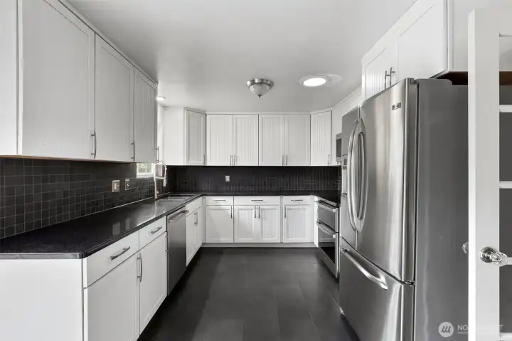 Kitchen includes a skylight with an integrated fan, allowing sun-drenched cooking space and optimal airflow for comfort and style