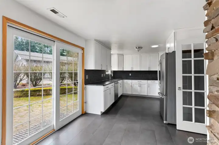 French doors enhance the kitchen entrance, providing a touch of Sophistication and seamless access to the heart of the home