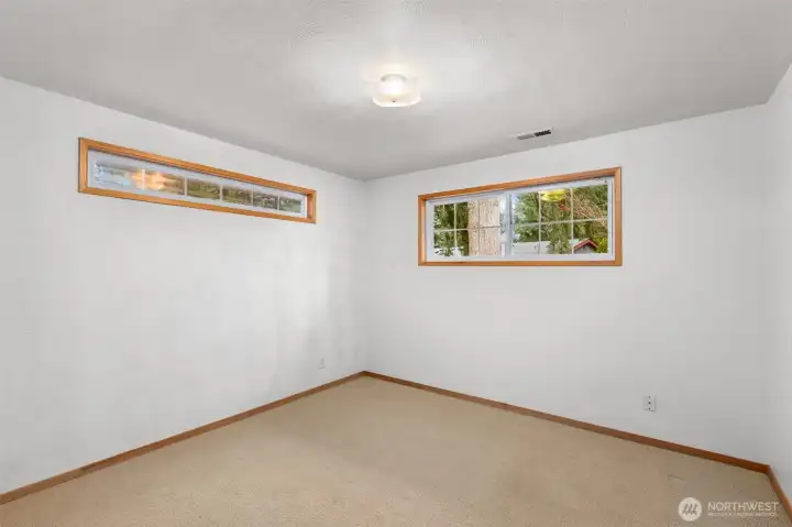 Spacious second bedroom featuring wall-to-wall carpet, offering comfort, warmth, and a welcoming atmosphere