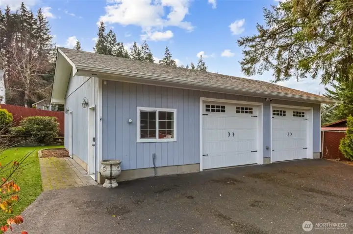 Detached two-car garage at the back of property, perfect for secure vehicle parking, additional storage and workshop space