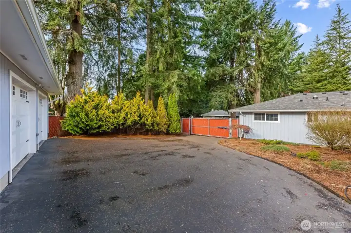 Additional paved driveway and parking space located in front of the garage, perfect for guests, RVs or extra vehicle with easy driveway access