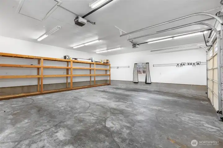 Detached garage interior equipped with built-in shelving, ideal for keeping tools, equipment, and belongings neatly organized with maximizing functional space