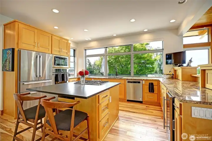 Kitchen with new center island granite and Thermador cooktop