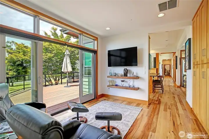 Family room with large TV and floating Shelves.