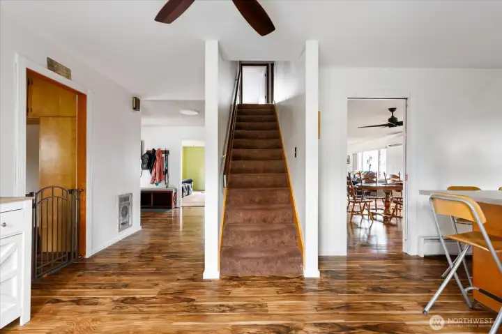 View from the back entry, looking toward the front entry, the stairway, and the entrance to the dining room.
