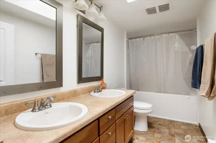 Upstairs full bathroom with dual vanity.