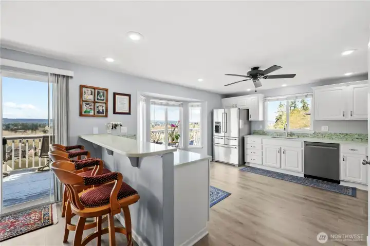 Convenient eating bar opens to the updated kitchen.