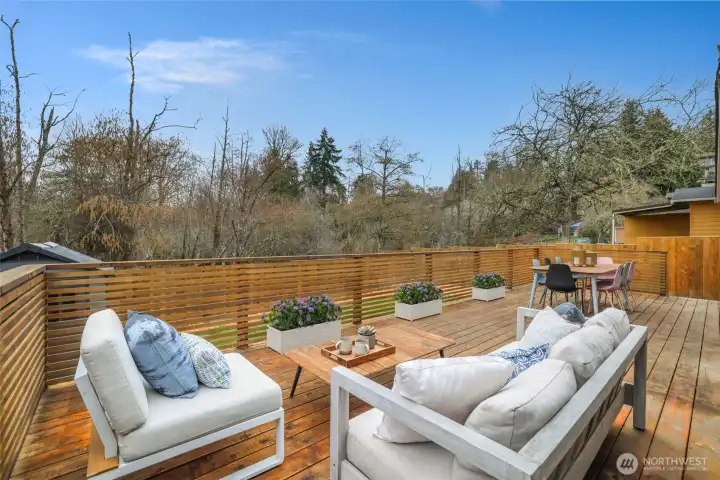 Expansive deck, perfect for entertaining. Planters are virtually staged.