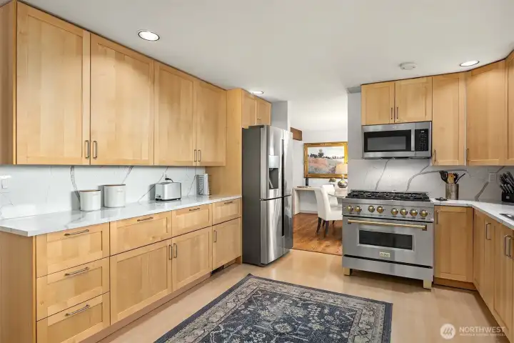 An abundance of cabinetry, plus lovely quartz countertops and backsplash for meal prep and staging.