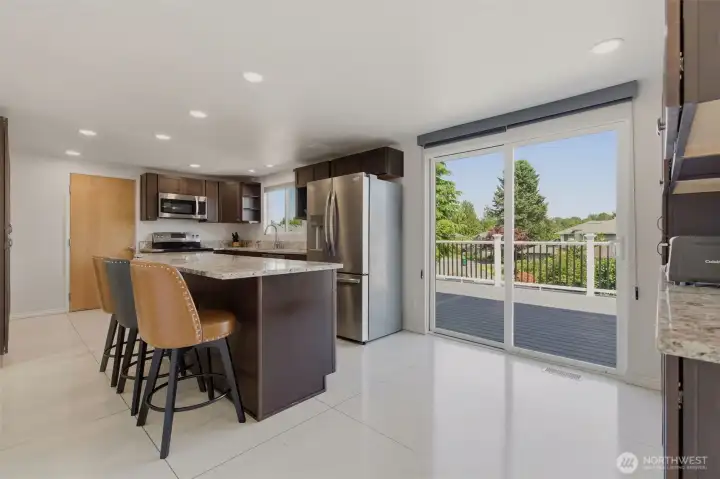 Kitchen with eating bar. Plus another slider to expansive deck.