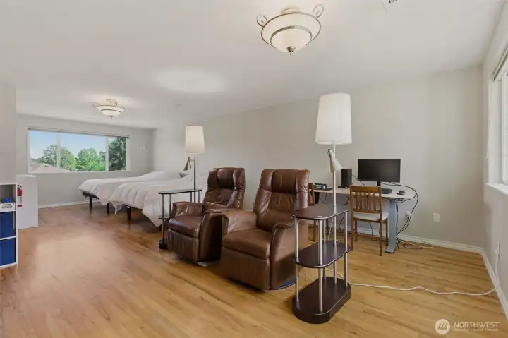 Huge primary bedroom is practically a studio apartment... room for sleeping + TV area + desk area