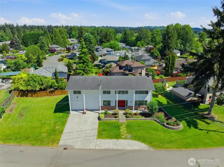 House sits on a knoll looking out over adjacent neighborhoods