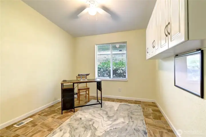 2nd of three bedrooms. Built-in cabinets here make an efficient office/craft room.