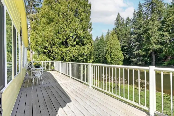 Fabulous composite deck, metal railings, runs the whole width of the house taking advantage of the lush, private ponds, woods.